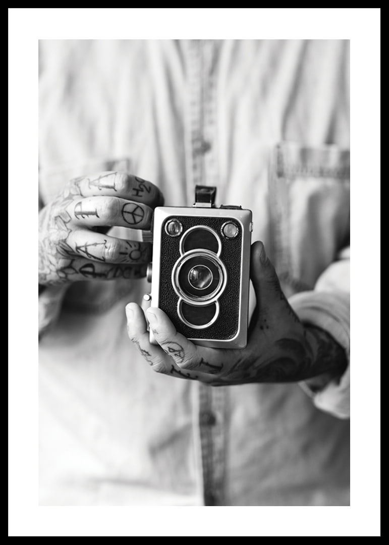 Black and white photo of tattooed hands holding a retro camera-12