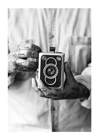 Black and white photo of tattooed hands holding a retro camera-1