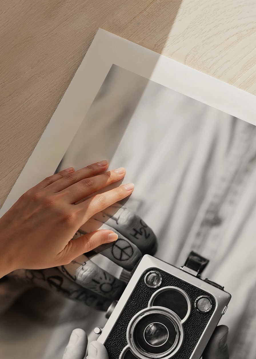 Black and white photo of tattooed hands holding a retro camera-12