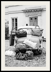 Black and white photo art with old car and suitcases outside house-2