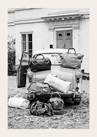 Black and white photo art with old car and suitcases outside house-3