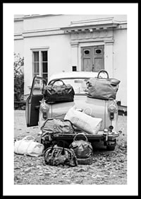 Black and white photo art with old car and suitcases outside house-0