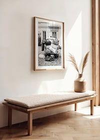 Black and white photo art with old car and suitcases outside house-8