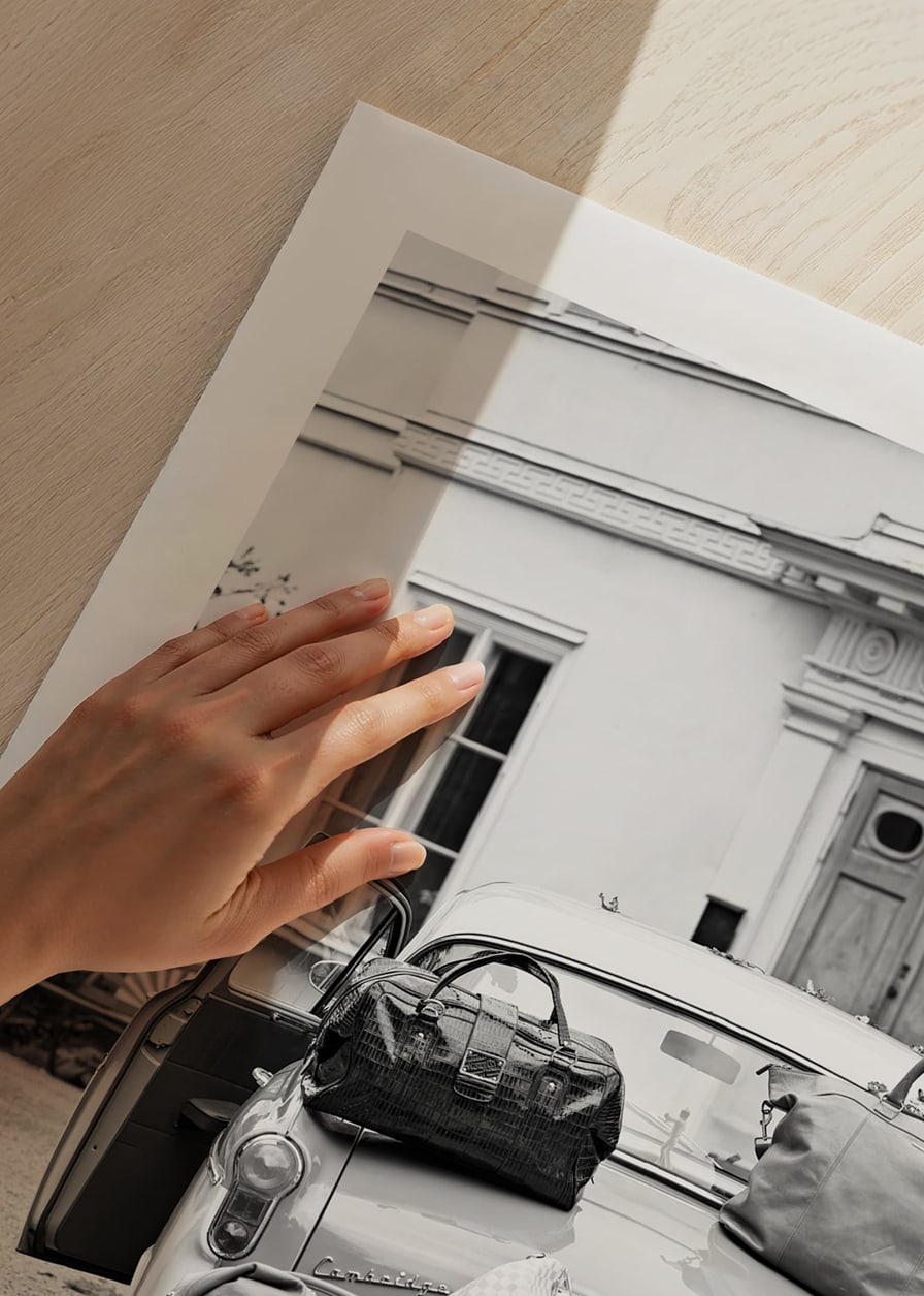Black and white photo art with old car and suitcases outside house-12