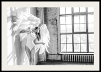 Black and white photo of woman with large angel wings by window-2
