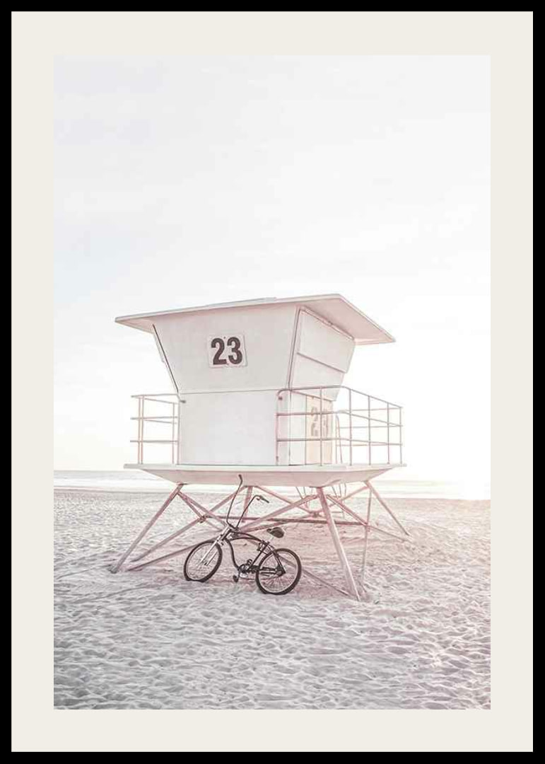 Photograph of white lifeguard tower on sandy beach in soft light-12