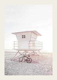 Photograph of white lifeguard tower on sandy beach in soft light-3
