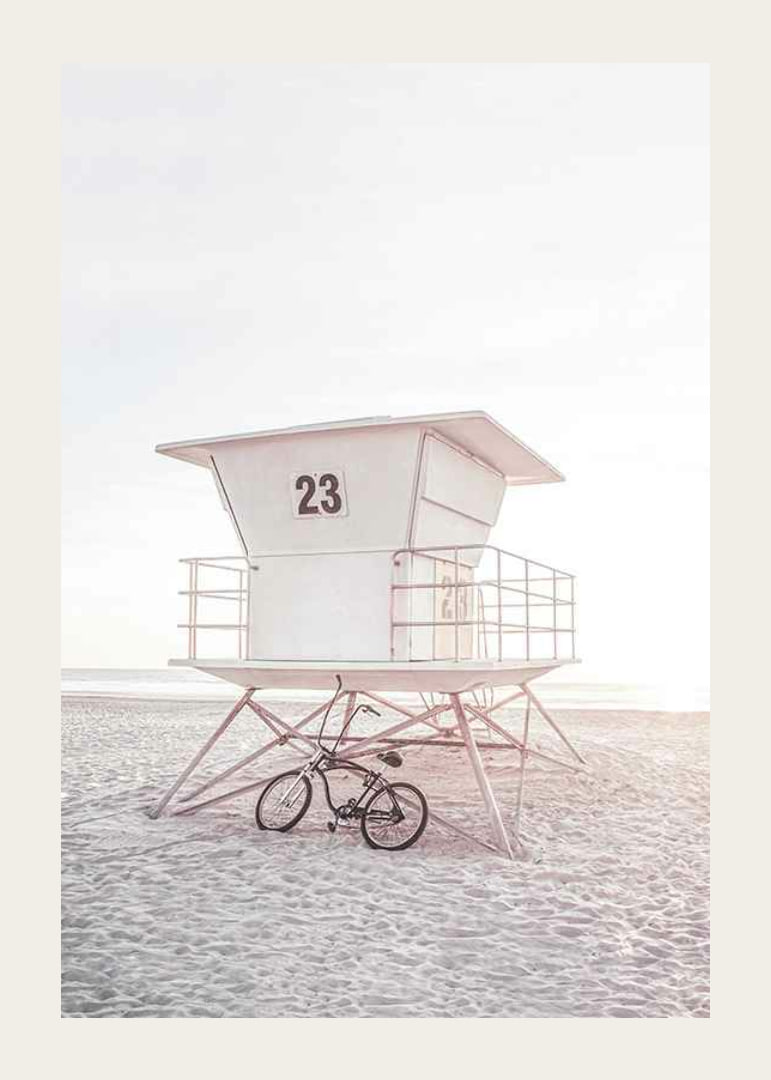Photograph of white lifeguard tower on sandy beach in soft light-12