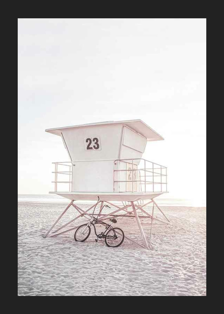Photograph of white lifeguard tower on sandy beach in soft light-12