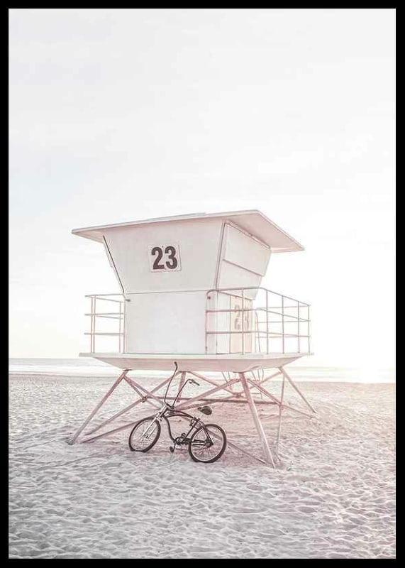 Photograph of white lifeguard tower on sandy beach in soft light-12