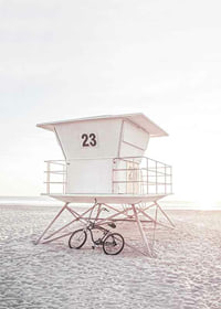 Photograph of white lifeguard tower on sandy beach in soft light-7