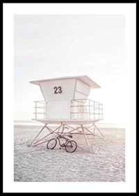 Photograph of white lifeguard tower on sandy beach in soft light-0