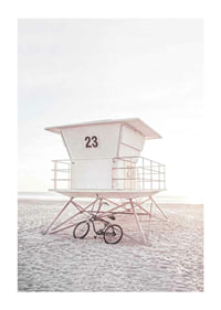 Photograph of white lifeguard tower on sandy beach in soft light-1