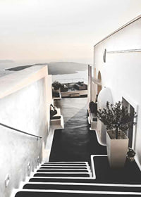 Whitewashed staircase in Santorini overlooking the sea-7