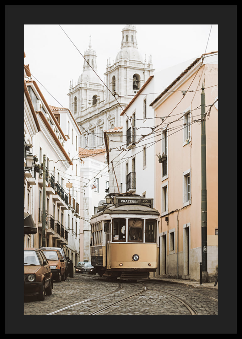 Photograph of yellow tram on narrow cobblestone street in Lisbon-12