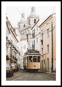 Photograph of yellow tram on narrow cobblestone street in Lisbon-0