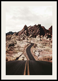 Asphalt road through reddish-brown rocks in desert landscape-2