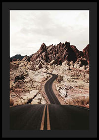 Asphalt road through reddish-brown rocks in desert landscape-4