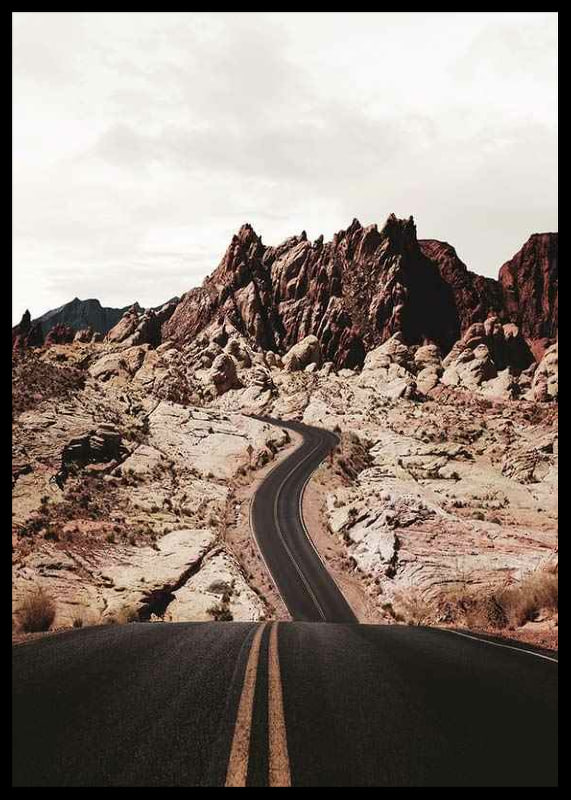 Asphalt road through reddish-brown rocks in desert landscape-12