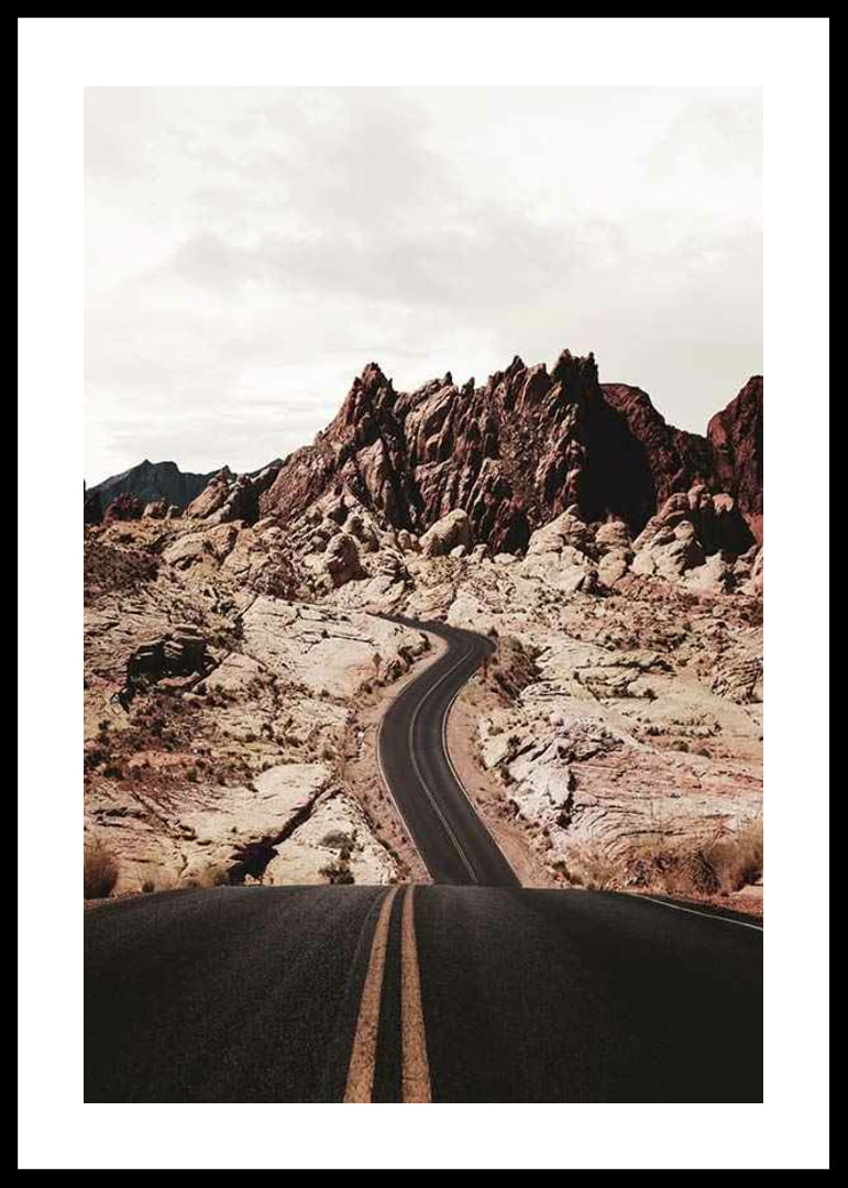 Asphalt road through reddish-brown rocks in desert landscape-12
