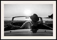 Black and white photography of couple in convertible at sunset over ocean-2