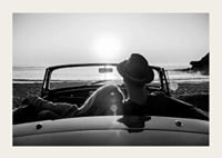 Black and white photography of couple in convertible at sunset over ocean-3
