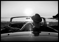Black and white photography of couple in convertible at sunset over ocean-6
