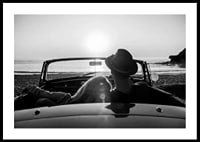 Black and white photography of couple in convertible at sunset over ocean-0