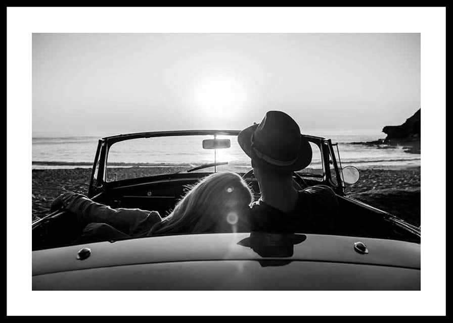 Black and white photography of couple in convertible at sunset over ocean-12