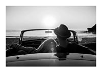 Black and white photography of couple in convertible at sunset over ocean-1