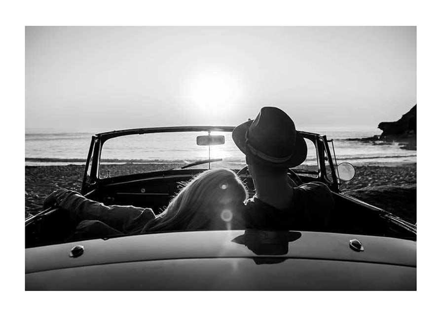 Black and white photography of couple in convertible at sunset over ocean-12