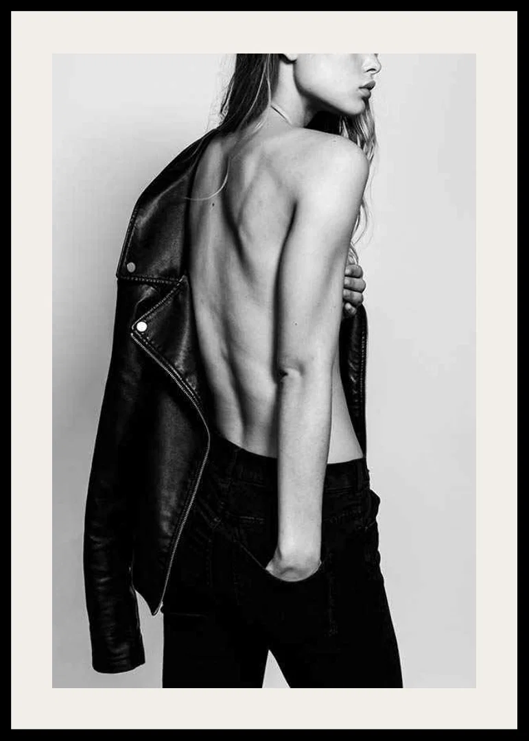 Black and white photo of young woman in jeans with leather jacket-12