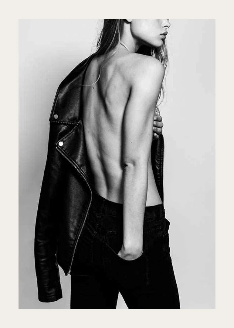 Black and white photo of young woman in jeans with leather jacket-12
