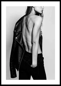 Black and white photo of young woman in jeans with leather jacket-0