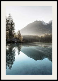 Photograph of calm lake with foggy mountains and fir trees-2