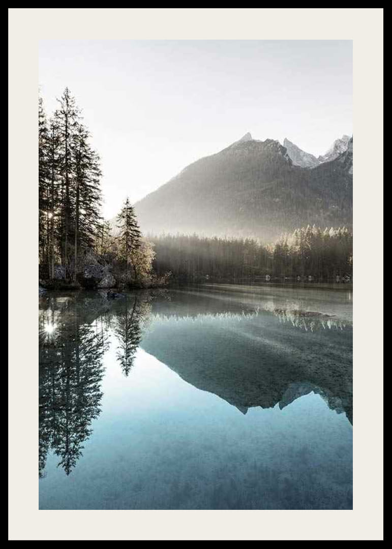 Photograph of calm lake with foggy mountains and fir trees-12
