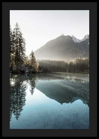 Photograph of calm lake with foggy mountains and fir trees-4