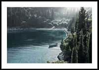 Photograph of lone boat on turquoise water at forested bay-0