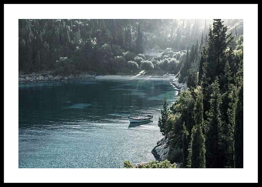 Photograph of lone boat on turquoise water at forested bay-12
