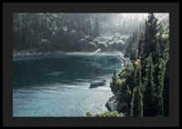 Photograph of lone boat on turquoise water at forested bay-4