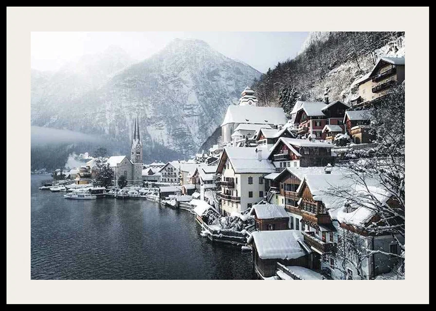 Photograph of Hallstatt by the lake, snow-covered houses and mountains-12