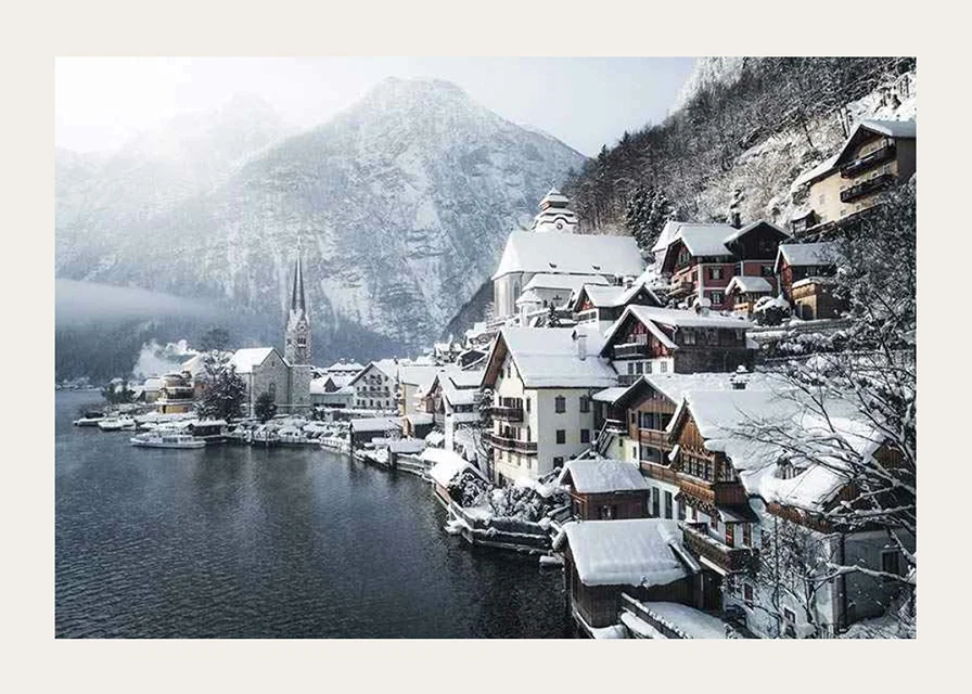 Photograph of Hallstatt by the lake, snow-covered houses and mountains-12