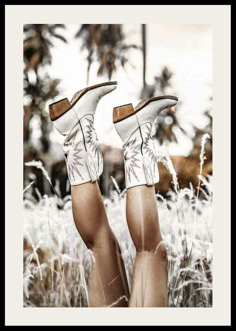 Photograph of legs with white cowboy boots in grass field-12