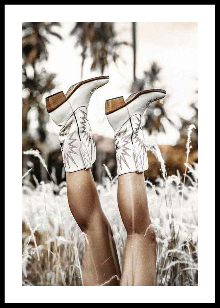 Photograph of legs with white cowboy boots in grass field-12