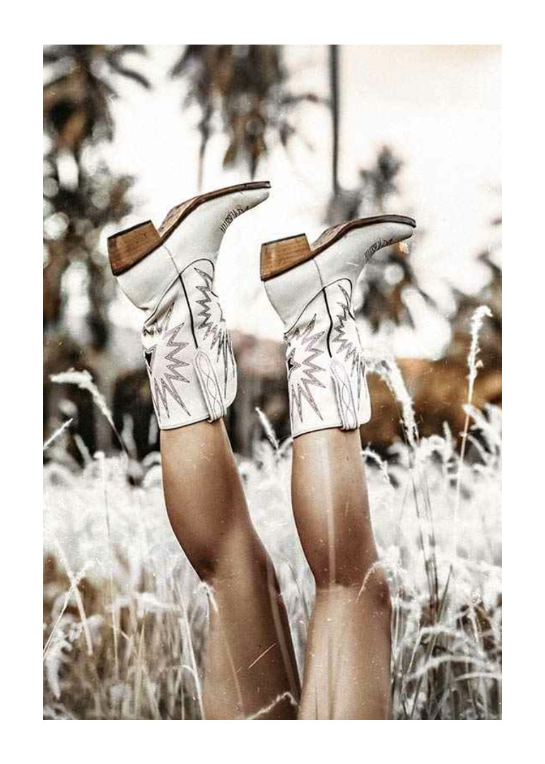 Photograph of legs with white cowboy boots in grass field-12