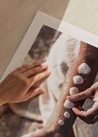 Photograph of arm with white shells on sunny beach-9