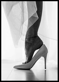 Black and white photograph of woman's feet put in white high heels-6
