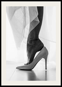 Black and white photograph of woman's feet put in white high heels-2