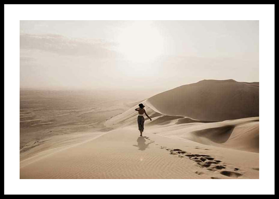 Photographic woman in hat on sand dunes in hot desert environment-12
