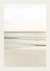 Photograph of calm sea at the beach in light beige tones-3